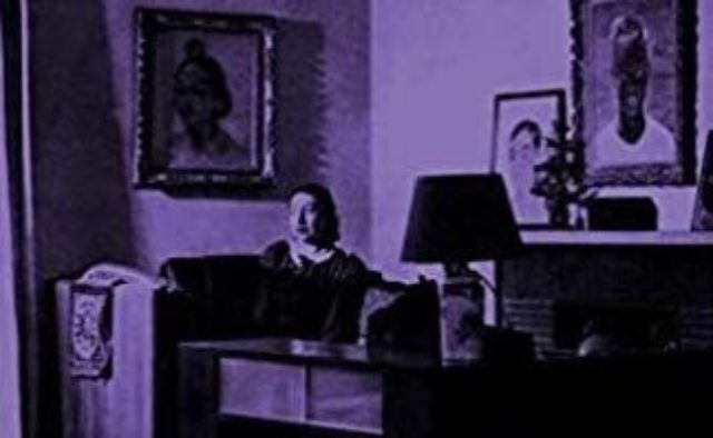woman sitting in living room purple